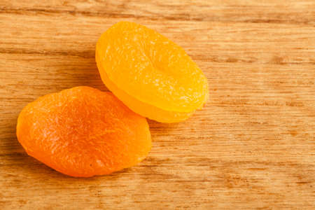 Healthy nutrition diet. Dried apricots on wooden table background.の写真素材