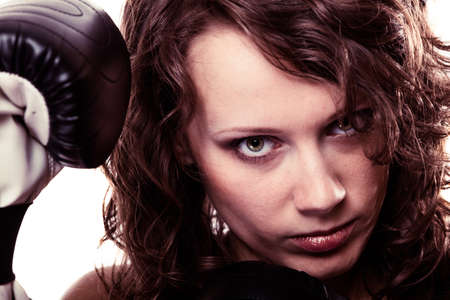 Martial arts or emancipation idea concept. Sport boxer woman in black gloves. Fitness girl training...