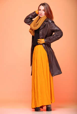 Fall. Fashion woman in autumn color fresh girl in full length long false orange eye-lashesの写真素材