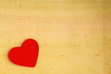 Valentine's day . Red decorative heart on wooden table with copy spaceの写真素材
