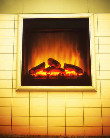 Closeup of electric artificial fireplace with orange fire flame interior as advertise billboard on...
