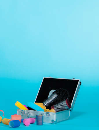 hairdressing. hair accessories tools hairdryer colorful curlers in suitcase. copy space for text....
