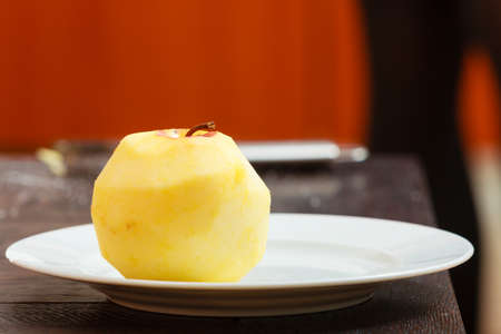 Closeup of peeled ripe apple fruit on white plate at home  Diet   healthy nutrition の写真素材