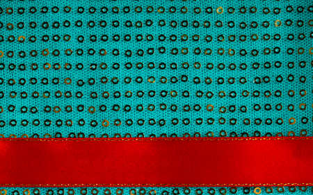 Green sequin texture abstract cloth  Elegant sequined sparkling textile with red ribbonの写真素材