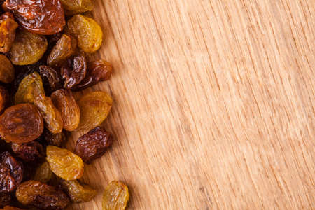 Healthy food organic nutrition  Border frame of raisin on wooden table の写真素材