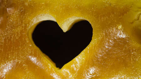 Macro. Closeup of amber with valentine heart love symbol as background or backdrop. Romantic gift.の写真素材