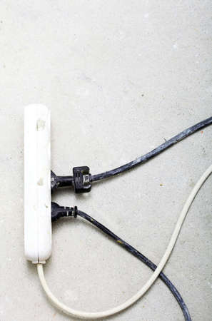 electrical cords connected to a power strip or extension block in construction siteの写真素材