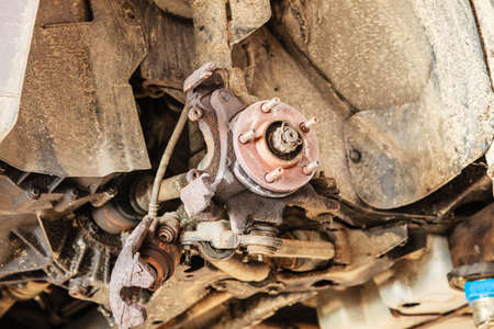 Car in service repairing. Closeup detail of the wheel assembly on automobileの写真素材