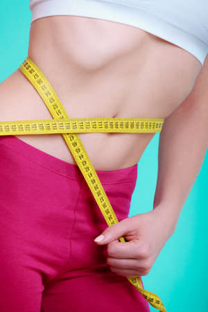 Time for diet slimming weight loss. Health care and healthy nutrition. Young fitness woman fit girl...