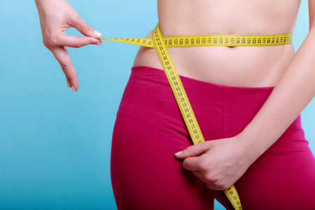 Time for diet slimming weight loss. Health care and healthy nutrition. Young fitness woman fit girl...