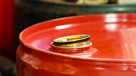 Car servicing  oil change. Red oil barrel canister in mechanic garage auto service or shop. Industry...