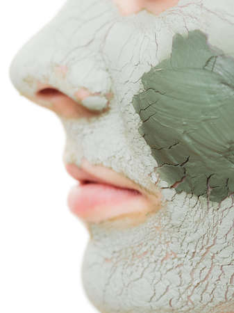 Skin care  Woman in clay mud mask on face isolated on white  Girl taking care of dry complexion  Beauty treatment の写真素材