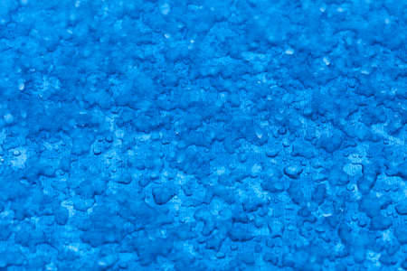 Macro close-up of melt snow as blue background or texture  Winter weather 