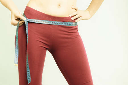 Diet slimming weight loss. Health care and healthy nutrition. Closeup of female body. Fitness woman...