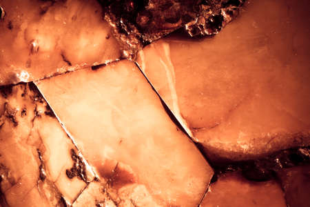  Closeup of amber as background texture or backdrop. Golden resin gem.
