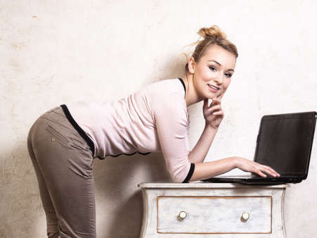 Technology internet modern lifestyle  Young businesswoman woman student girl working on computer laptop at the retro desk  Business at home の写真素材