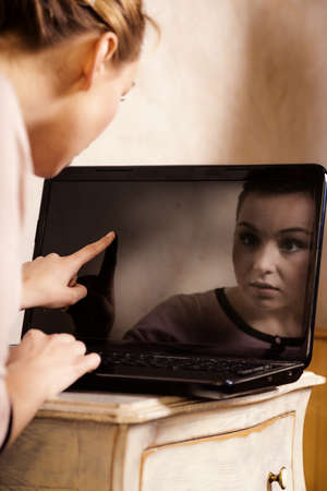 Technology internet modern lifestyle. Young businesswoman woman student girl working on computer laptop touching screen. Business at home.の写真素材