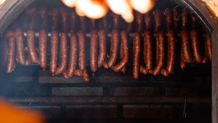 Traditional food. Smoked sausages meat hanging in domestic smokehouse.の写真素材