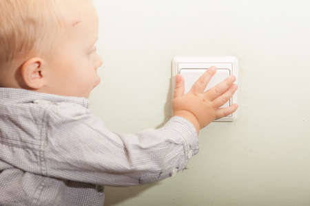 Happy childhood  Baby boy turning on or off the light  Child kid playing with switch  At home の写真素材