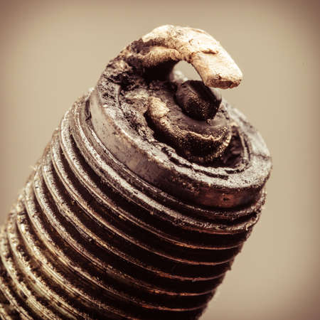 Auto service  Old rusty spark plug as spare part of car transportation on gray の写真素材