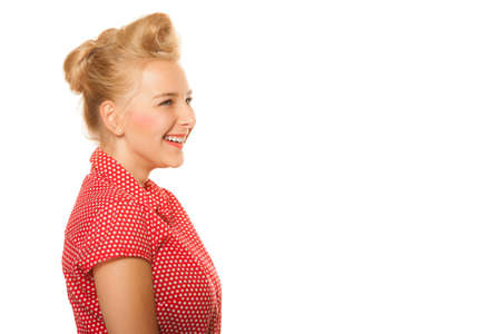 Portrait of pin-up blond girl with hair bun isolated on white. Young woman in retro style. Copy space. Studio shot.の写真素材