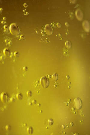 Green yellow abstract blurred liquid background with soap bubbles