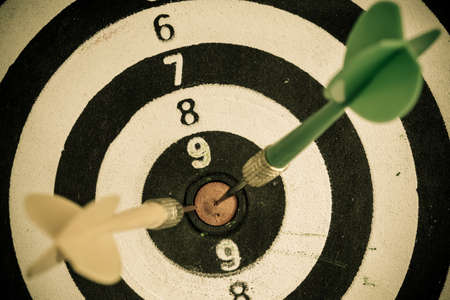 Closeup of old dirty black and white target with two darts as sport background  Skeet trap shooting の写真素材