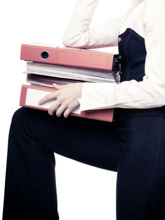 Business and paperwork. Stack of folders with files documents in hands of tired overworked busy businesswoman isolated on white.の写真素材