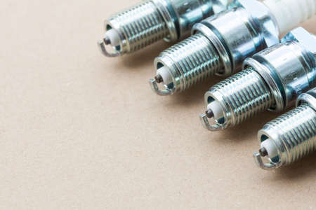 Auto service  Set of new car spark plugs as spare part of auto transportation on grayの写真素材
