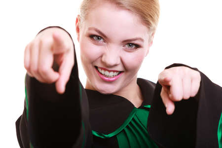 Law court or justice concept  Happy young woman lawyer attorney wearing classic polish  Poland  black green gown celebrating success victory, point finger at you isolated on white backgroundの写真素材