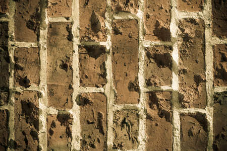 Old grungy destroyed of a red brick wall texture