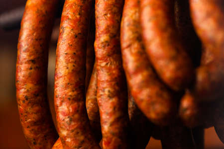 Traditional food. Smoked sausages meat hanging in domestic smokehouse.の写真素材