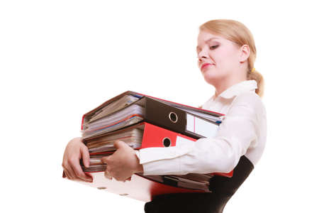 Business and paperwork  Tired overworked busy businesswoman carrying stack of folders with files documents isolated on whiteの写真素材