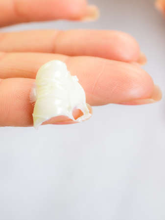 Skincare. Woman taking care of her dry complexion. Moisturizing cream on female hand isolated. Beauty treatment.の写真素材