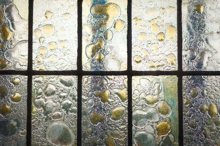 stained glass window with regular block pattern in hue of blue