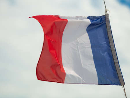 Flag of France waving in the breeze sky backgroundの写真素材