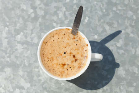 Cup of coffee cappuccino with froth hot drink on gray backgroundの写真素材