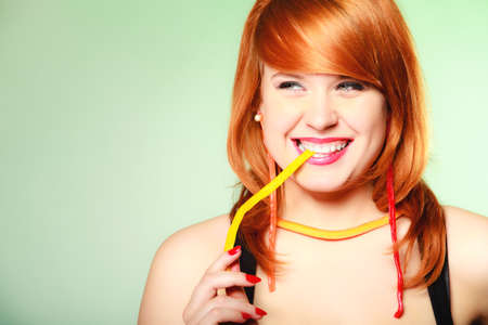 red hair cute funny girl with sweet jelly on greenの写真素材