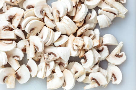 Vegetarian food. Closeup of slices of fresh white mushrooms champigonons.の写真素材