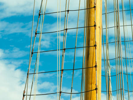 Yachting. Sailboat view of different parts of yacht. Mast against blue summer skyの写真素材