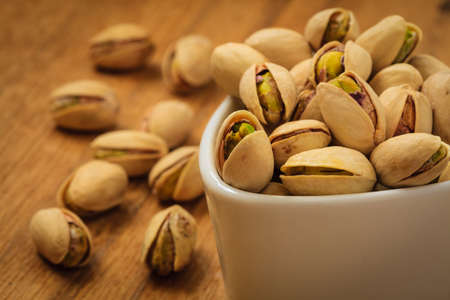 Diet healthcare concept. Roasted pistachio nuts seed with shell close upの写真素材