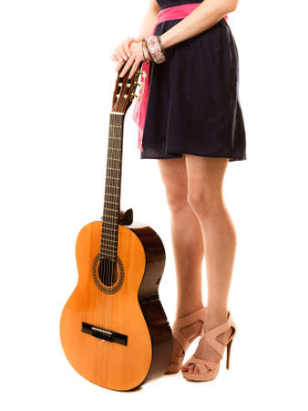 Travel vacation concept. Music lover summer girl holding acoustic guitar isolated on whiteの写真素材