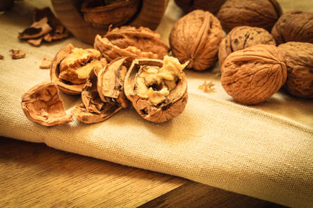 Healthy food full of omega-3 fatty acids, organic nutrition. Walnut with nutcracker on rustic old...