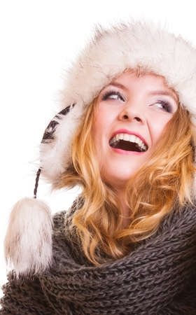Winter fashion. Portrait positive teen girl in warm clothes. Happy young woman in fur hat doing fun isolated.の写真素材