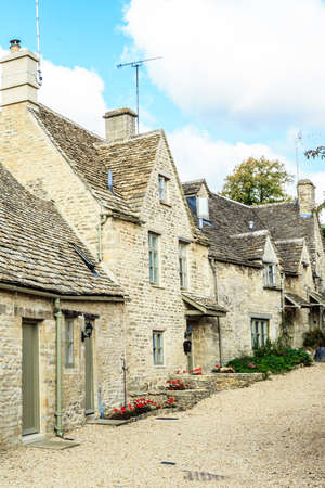 BIBURY, ENGLAND, UK - SEPTEMBER 21, 2014: Traditional Cotswold cottages in Gloucestershire on September 21, 2014, England. Bibury it the most depicted village in the world.のeditorial素材