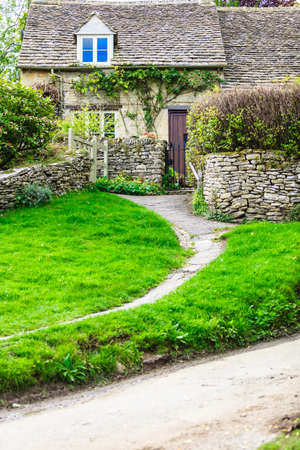 BIBURY, ENGLAND, UK - SEPTEMBER 21, 2014: Traditional Cotswold cottages in Gloucestershire on September 21, 2014, England. Bibury it the most depicted village in the world.のeditorial素材