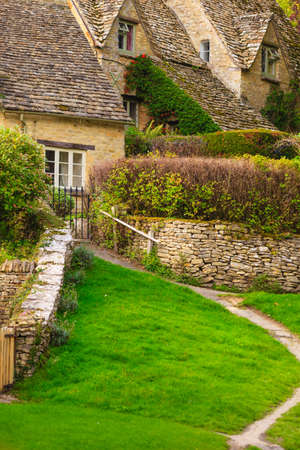 BIBURY, ENGLAND, UK - SEPTEMBER 21, 2014: Traditional Cotswold cottages in Gloucestershire on September 21, 2014, England. Bibury it the most depicted village in the world.のeditorial素材
