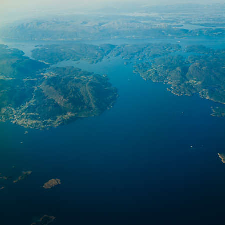 Birds eye. View from window of plane airplane flying over Norway Scandinavia.