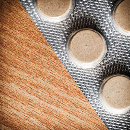 Medical background backdrop with pills tablets drugs on wooden table. Pharmacy.の写真素材