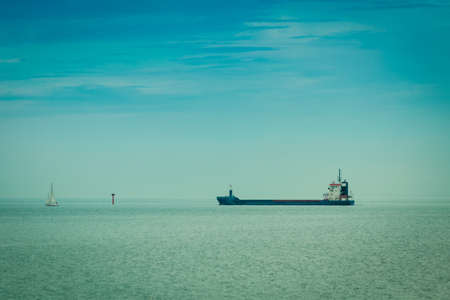 Transportation, cargo conteiner ship sailing in still water near port of Gdansk Poland.の写真素材